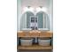 Bathroom with double sinks, wood vanity, and white subway tile at 4237 Foxglove Trce, Indianapolis, IN 46237