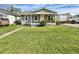 Charming bungalow with a spacious front yard and covered porch at 4014 E 10Th St, Indianapolis, IN 46201