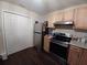 Modern kitchen with stainless steel appliances and wood cabinets at 3002 N Olney St, Indianapolis, IN 46218