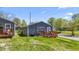 Gray house with wooden deck and side yard, showing a street at 3002 N Olney St, Indianapolis, IN 46218