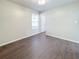 Well-lit bedroom with dark wood-look floors and window at 3002 N Olney St, Indianapolis, IN 46218