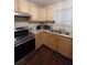 Kitchen with stainless steel appliances and light wood cabinets at 3002 N Olney St, Indianapolis, IN 46218