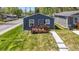 Newly built blue house with wood deck and walkway at 3002 N Olney St, Indianapolis, IN 46218