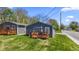 Gray house with a wooden deck and grassy yard, side view at 3002 N Olney St, Indianapolis, IN 46218