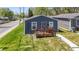Newly built gray house with a deck, steps, and a grassy lawn at 3002 N Olney St, Indianapolis, IN 46218