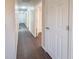 Clean hallway with dark hardwood floors and access to bedrooms and bathroom at 3002 N Olney St, Indianapolis, IN 46218