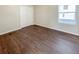 Simple bedroom with dark wood-look floors and double door closet at 3002 N Olney St, Indianapolis, IN 46218