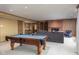 Basement game room with pool table, fireplace, and built-in shelving at 3748 Bay Rd S Dr, Indianapolis, IN 46240