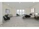 Main bedroom with grey carpet, large windows, and staged furniture at 421 S Randolph St, Indianapolis, IN 46201