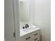 Small bathroom with white vanity, black faucets, and a framed mirror at 421 S Randolph St, Indianapolis, IN 46201