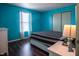 Bedroom with teal walls, dark hardwood floors, and a queen-size bed at 8628 Hosta Way, Camby, IN 46113