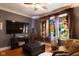 Relaxing living room with stained glass windows and a flat-screen TV at 675 Woodruff Place West Dr, Indianapolis, IN 46201