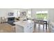 Open concept kitchen with island and white cabinetry at 6941 E Bean Blossom Dr, Camby, IN 46113