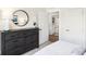 Well-lit bedroom with large dresser, ensuite bathroom access, and plush bedding at 6941 E Bean Blossom Dr, Camby, IN 46113