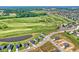 Aerial view showcasing new homes near golf course and pond at 6941 E Bean Blossom Dr, Camby, IN 46113