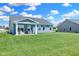 Large backyard with grassy lawn and covered patio at 6941 E Bean Blossom Dr, Camby, IN 46113