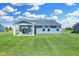Spacious backyard with grassy lawn and covered patio at 6941 E Bean Blossom Dr, Camby, IN 46113