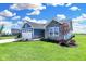 Blue and gray house with stone accents and landscaping at 6941 E Bean Blossom Dr, Camby, IN 46113