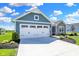 Two-car garage with white doors and blue siding at 6941 E Bean Blossom Dr, Camby, IN 46113