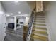 Basement stairs with an open railing leading to a finished basement at 8827 El Rico Dr, Indianapolis, IN 46240