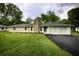 Ranch home with stone facade, attached two-car garage, and landscaped lawn at 8827 El Rico Dr, Indianapolis, IN 46240