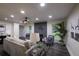 Open living room with fireplace and large windows at 8827 El Rico Dr, Indianapolis, IN 46240