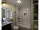 Modern bathroom with white subway tiles, a shower/tub combo, and built-in shelving at 8827 El Rico Dr, Indianapolis, IN 46240