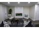 Finished basement with a cozy sitting area, fireplace, and hardwood floors at 8827 El Rico Dr, Indianapolis, IN 46240