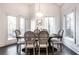 Bright dining room with a wooden table and six chairs, near a balcony at 1336 Central Ave, Indianapolis, IN 46202