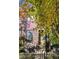 Brick home with autumn foliage, inviting front porch, and a black metal fence at 1336 Central Ave, Indianapolis, IN 46202