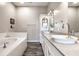 Spa-like bathroom with double sinks, large tub, and modern finishes at 1336 Central Ave, Indianapolis, IN 46202