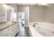 Elegant bathroom with soaking tub, double vanity, and updated fixtures at 1336 Central Ave, Indianapolis, IN 46202