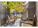 Small patio with wooden chairs and a table, perfect for relaxing outdoors at 1336 Central Ave, Indianapolis, IN 46202