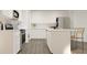 White kitchen with stainless steel appliances and island at 3798 Andean Dr, Bargersville, IN 46106