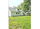 White house with gray roof, detached garage, and a large grassy yard at 1515 S Park Ave, Alexandria, IN 46001