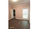 Bedroom with hardwood floors, pink walls, and a view of the garden at 1515 S Park Ave, Alexandria, IN 46001