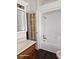 Bathroom with shower/tub combo, wood vanity, and a glass door at 1515 S Park Ave, Alexandria, IN 46001