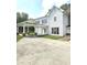 Two story white house with a brick carport and large windows at 1515 S Park Ave, Alexandria, IN 46001