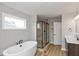 Modern bathroom featuring a soaking tub and walk-in shower at 15287 Garden Mist Pl, Fishers, IN 46037