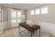 Home office with a desk, large windows, and neutral color palette at 15287 Garden Mist Pl, Fishers, IN 46037