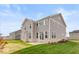 Two-story house with gray siding, stone accents, and a patio at 15287 Garden Mist Pl, Fishers, IN 46037