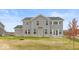 Rear view of two-story house with gray siding and stone accents at 15287 Garden Mist Pl, Fishers, IN 46037