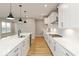 Modern kitchen with white cabinets, quartz countertops and stainless steel appliances at 15287 Garden Mist Pl, Fishers, IN 46037