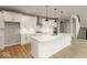 Modern kitchen with white cabinets, quartz countertops, and a large island at 15287 Garden Mist Pl, Fishers, IN 46037