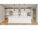 Modern kitchen with white cabinets, quartz countertops, and a large island at 15287 Garden Mist Pl, Fishers, IN 46037
