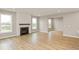 Living room with hardwood floors, fireplace, and shiplap accent wall at 15287 Garden Mist Pl, Fishers, IN 46037