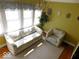 Cozy sitting room with sofa, armchair, and large windows at 909 E 38Th St, Indianapolis, IN 46205