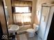 Clean bathroom with pedestal sink, toilet, and shower at 909 E 38Th St, Indianapolis, IN 46205