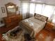 Bright bedroom with a queen-size bed and wood dresser at 909 E 38Th St, Indianapolis, IN 46205