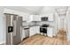 Modern kitchen featuring stainless steel appliances and white cabinetry at 1818 Ingram St, Indianapolis, IN 46218